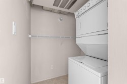 Dedicated laundry space featuring a white stacked washer and dryer unit, wire shelving, and neutral wall tones - 