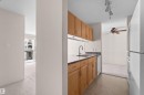 Functional kitchen featuring wood cabinetry, laminate countertops, a stainless steel sink, and a white dishwasher - #224 16303 95 St Nw, Edmonton, AB  - Indoor Photo Showing Kitchen 