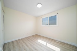 Neutral painted walls complement wood-finish flooring - 