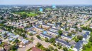 Aerial perspective showcasing a residential community with townhome-style residences and single-story homes - 11432 139 Avenue Nw, Edmonton, AB  - Outdoor With View 