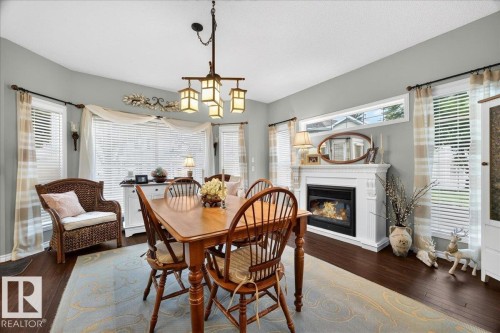#52 1780 Glastonbury Bv Nw, Edmonton, AB - Indoor Photo Showing Dining Room With Fireplace