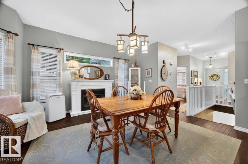 #52 1780 Glastonbury Bv Nw, Edmonton, AB - Indoor Photo Showing Dining Room With Fireplace