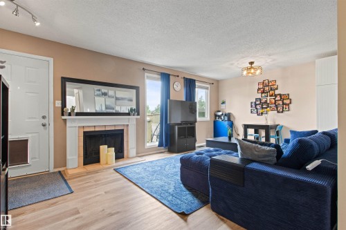 #64 3221 119 St Nw, Edmonton, AB - Indoor Photo Showing Living Room With Fireplace