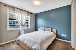 Bedroom featuring a bold accent wall, neutral carpeting, and a flush mount ceiling light - 