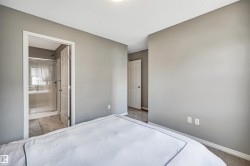 Bedroom featuring neutral gray walls and carpeted flooring - 