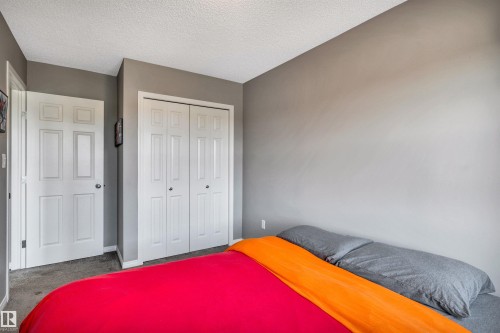 Neutral-toned wall finishes throughout - 571 Orchards Boulevard Sw, Edmonton, AB - Indoor Photo Showing Bedroom