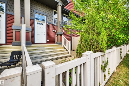 Red siding exterior with gray shake accents and white trim - 571 Orchards Boulevard Sw, Edmonton, AB - Outdoor