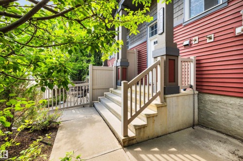 Entryway featuring concrete steps and a coordinating handrail leading to the property - 571 Orchards Boulevard Sw, Edmonton, AB - Outdoor With Exterior