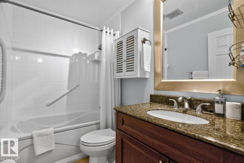 Full bathroom featuring a white tub/shower combination with grab bar, a white toilet, and a vanity with a granite-style countertop - 27 Milford Crescent, Sherwood Park, AB - Indoor Photo Showing Bathroom