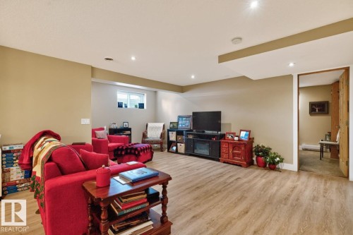 Finished lower level featuring wood-finish flooring, recessed lighting, and a window for natural light - 27 Milford Crescent, Sherwood Park, AB - Indoor