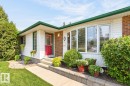 White siding exterior with brick accents, featuring a prominent red entry door - 27 Milford Crescent, Sherwood Park, AB  - Outdoor 