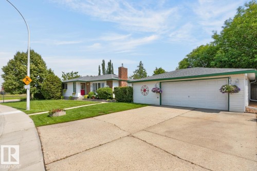 Ranch-style residence featuring a prominent red entry door, white siding, and a brick chimney - 27 Milford Crescent, Sherwood Park, AB - Outdoor