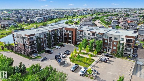 Multi-story residential building with contemporary architectural design, featuring a mix of brick and panel siding - #435 1008 Rosenthal Bv Nw, Edmonton, AB - Outdoor With Balcony With View