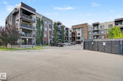 Contemporary multi-story building featuring a facade with mixed materials including brick, stucco, and wood-finish accents - 