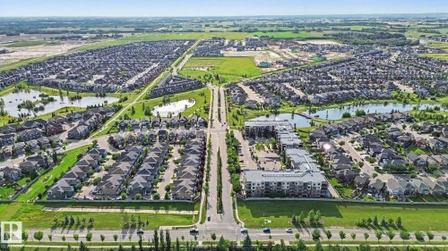 Expansive residential development featuring detached homes and multi-story apartment buildings - #435 1008 Rosenthal Bv Nw, Edmonton, AB - Outdoor With View