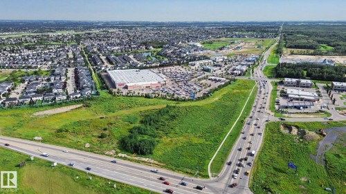 Expansive aerial view of a vibrant community featuring residential developments and commercial establishments - #435 1008 Rosenthal Bv Nw, Edmonton, AB - Outdoor With View