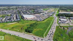 Expansive aerial view of a vibrant community featuring residential developments and commercial establishments - 