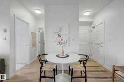 Entryway featuring wood-finish flooring, recessed lighting, and white paneled doors - 