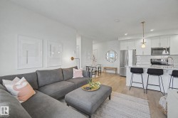 Open-concept living space featuring wood-finish flooring throughout - 