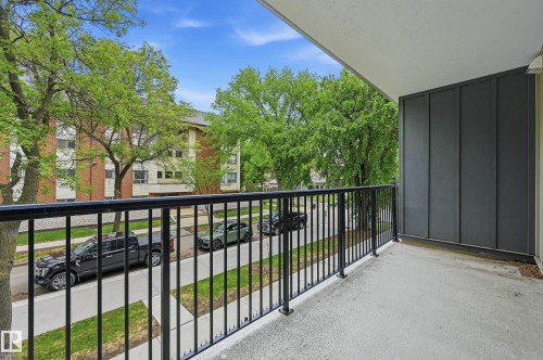 Outdoor balcony space featuring a concrete floor and black metal railing - #203 11103 84 Av Nw, Edmonton, AB - Outdoor With Balcony With Exterior