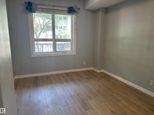 Room with a window and wood-finish flooring - #203 11103 84 Av Nw, Edmonton, AB - Indoor Photo Showing Other Room