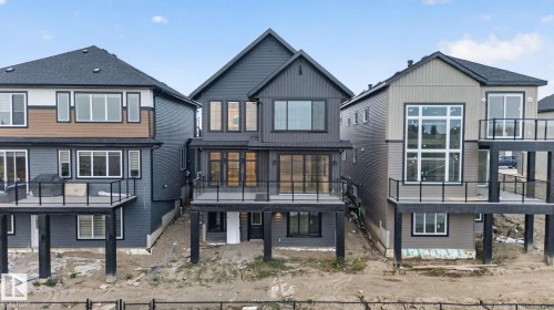 Modern multi-level residence featuring dark gray siding and a prominent gabled roofline - 8791 Mayday Ln Sw Sw, Edmonton, AB - Outdoor With Deck Patio Veranda With Facade
