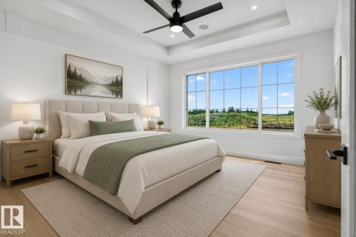 Room featuring a tray ceiling with a ceiling fan, light wood-finish flooring, and a large window with multiple panes - 8791 Mayday Ln Sw Sw, Edmonton, AB - Indoor Photo Showing Bedroom