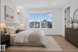Bedroom featuring a large multi-pane window, light wood-finish flooring, recessed lighting, and white wall paneling - 