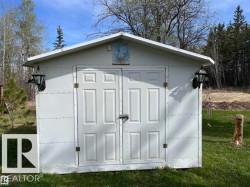 White storage shed with a peaked roof - 