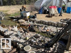 Outdoor water feature with natural stone and wood-cut borders - 