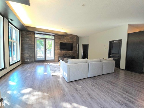 #106 10531 117 St Nw, Edmonton, AB - Indoor Photo Showing Living Room With Fireplace