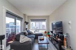 Open living area with wood-finish flooring and light gray walls - 