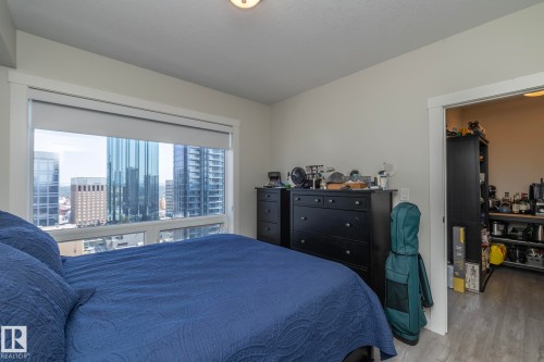 Expansive window offering urban high-rise panoramas - #2402 10410 102 Av Nw, Edmonton, AB - Indoor Photo Showing Bedroom