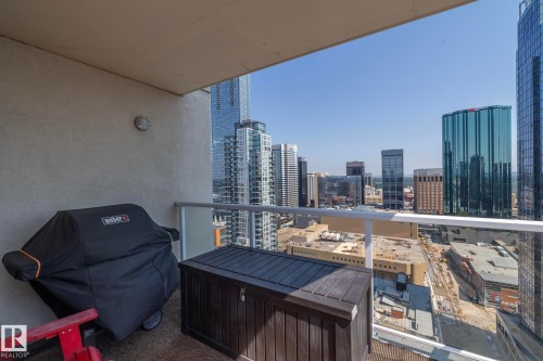 Private balcony with frosted glass railing and cityscape backdrop - #2402 10410 102 Av Nw, Edmonton, AB - Outdoor With Balcony With Exterior