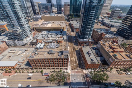 Urban landscape featuring high-rise towers, multi-story brick buildings, and street-level infrastructure - #2402 10410 102 Av Nw, Edmonton, AB - Outdoor With View