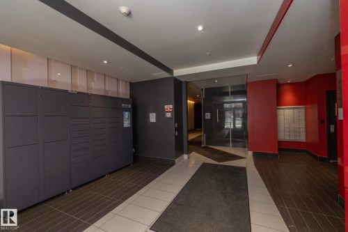Lobby area featuring parcel lockers and individual mailboxes - #2402 10410 102 Av Nw, Edmonton, AB - Indoor Photo Showing Other Room