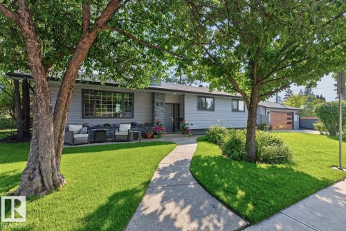 Contemporary-style residence featuring light gray siding with stone veneer accents - 4631 113A Street Nw, Edmonton, AB - Outdoor