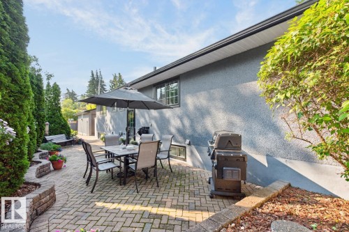 Expansive brick paver patio featuring a retaining wall - 4631 113A Street Nw, Edmonton, AB - Outdoor With Deck Patio Veranda