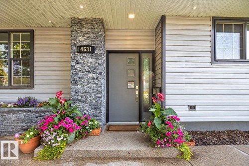 Entryway featuring a grey front door with square glass inserts and a sidelight - 4631 113A Street Nw, Edmonton, AB - Outdoor With Exterior