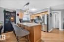 Kitchen featuring stainless steel appliances, light wood cabinetry, and a stone backsplash - #306 13111 140 Av Nw, Edmonton, AB  - Indoor Photo Showing Kitchen 