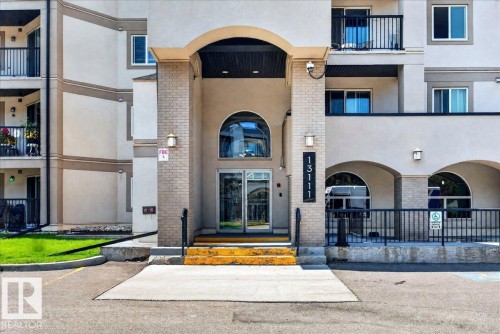 Building entrance featuring a prominent arched portico - #306 13111 140 Av Nw, Edmonton, AB - Outdoor With Balcony With Facade