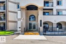 Building entrance featuring a prominent arched portico - #306 13111 140 Av Nw, Edmonton, AB  - Outdoor With Balcony With Facade 