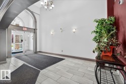 Entryway featuring arched architectural details, light-toned tile flooring, recessed wall sconces, and a contemporary ceiling light fixture - 