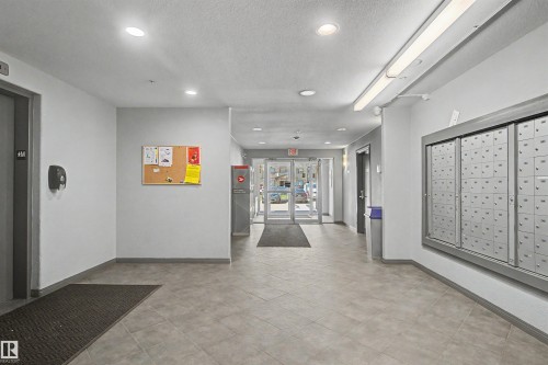 Building entryway featuring tile flooring, recessed lighting, fluorescent overhead lighting, and built-in mailboxes - #204 309 Clareview Station Dr Nw, Edmonton, AB - Indoor Photo Showing Other Room