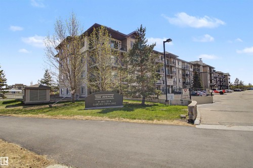 Multi-story building featuring balconies, a paved parking area, and a prominent "The Avenue" sign - #204 309 Clareview Station Dr Nw, Edmonton, AB - Outdoor