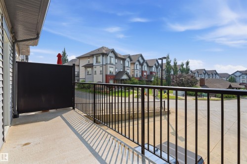 Private balcony featuring a concrete surface and black metal railings - #62 675 Watt Bv Sw, Edmonton, AB - Outdoor With Balcony With Exterior