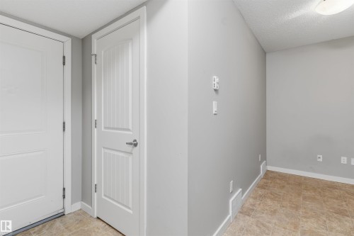 Entryway featuring neutral-toned ceramic tile flooring and light gray painted walls - #62 675 Watt Bv Sw, Edmonton, AB - Indoor Photo Showing Other Room