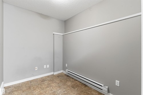 Neutral gray walls with white trim and a textured ceiling - #62 675 Watt Bv Sw, Edmonton, AB - Indoor Photo Showing Other Room