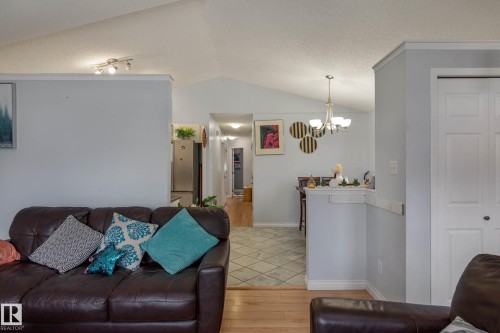 Vaulted ceiling living space featuring light wood-finish flooring, recessed lighting, and soft gray wall tones - 9113 166 Avenue Nw, Edmonton, AB - Indoor Photo Showing Living Room