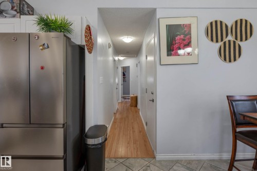 Hallway with wood-finish flooring and recessed lighting - 9113 166 Avenue Nw, Edmonton, AB - Indoor Photo Showing Other Room